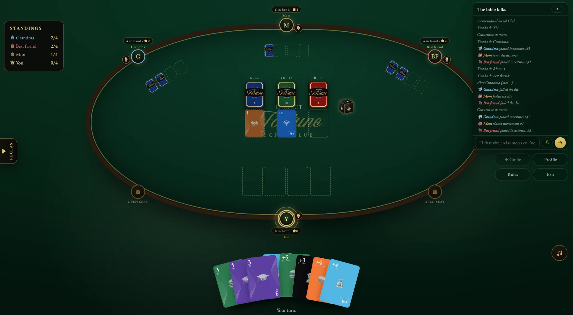 Market Fortune online table: green felt with a gold frame, four players, the three decks and your hand of cards.